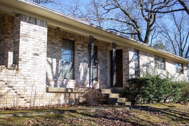 property entrance with brick siding