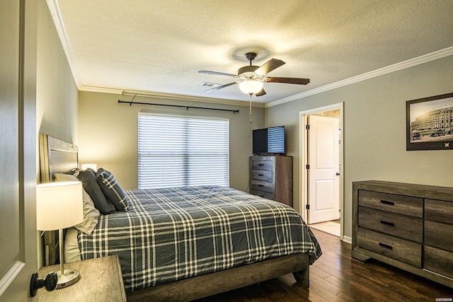 bedroom with wood finished floors, visible vents, and crown molding