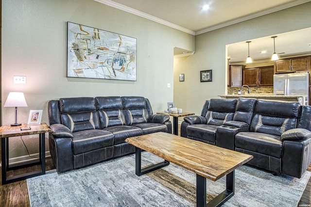 living room featuring ornamental molding and wood finished floors