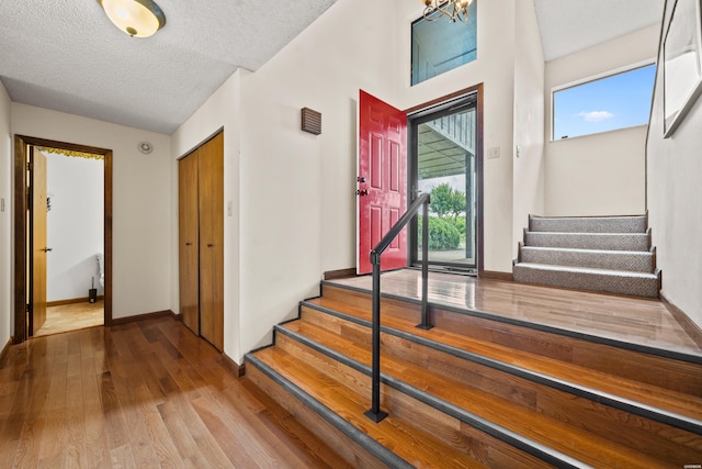 105 Long Island Bay Unit A1, Hot Springs, AR 71913 - entrance foyer featuring wood finished floors, stairs, plenty of natural light, and a textured ceiling