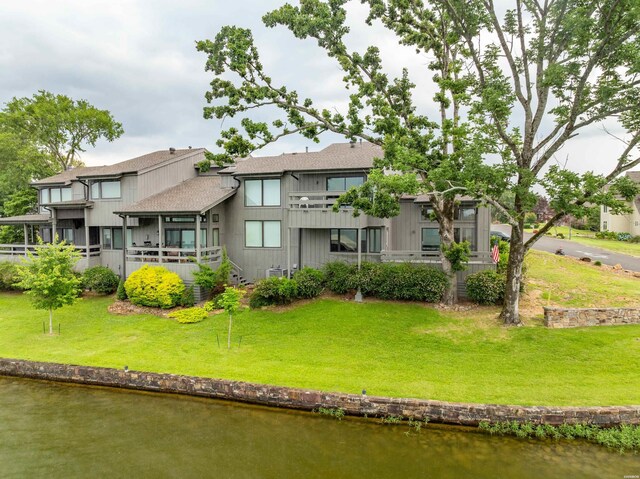105 Long Island Bay Unit A1, Hot Springs, AR 71913 - back of property featuring a water view, a yard, and roof with shingles