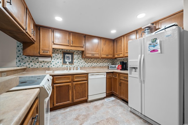 105 Long Island Bay Unit A1, Hot Springs, AR 71913 - kitchen with white appliances, brown cabinets, light countertops, decorative backsplash, and recessed lighting