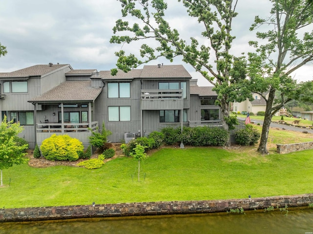105 Long Island Bay Unit A1, Hot Springs, AR 71913 - rear view of house featuring a shingled roof, a balcony, and a lawn
