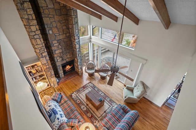 105 Long Island Bay Unit A1, Hot Springs, AR 71913 - living room with beamed ceiling, wood finished floors, a fireplace, a high ceiling, and ceiling fan