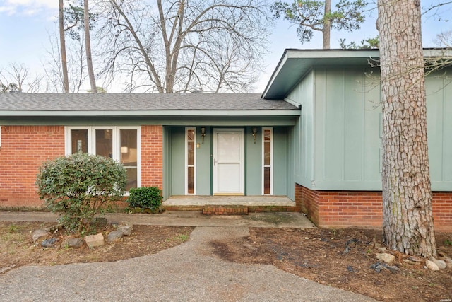 property entrance with a shingled roof