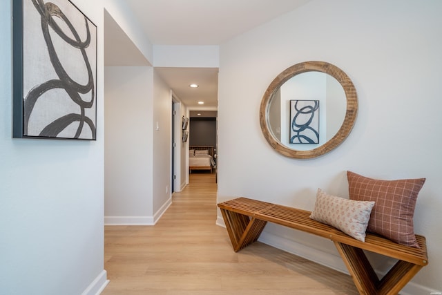 corridor with recessed lighting, light wood-style flooring, and baseboards