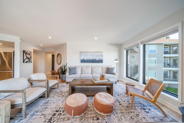 living room featuring baseboards and recessed lighting