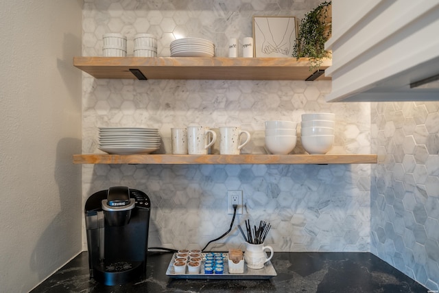 room details featuring dark countertops, decorative backsplash, and open shelves