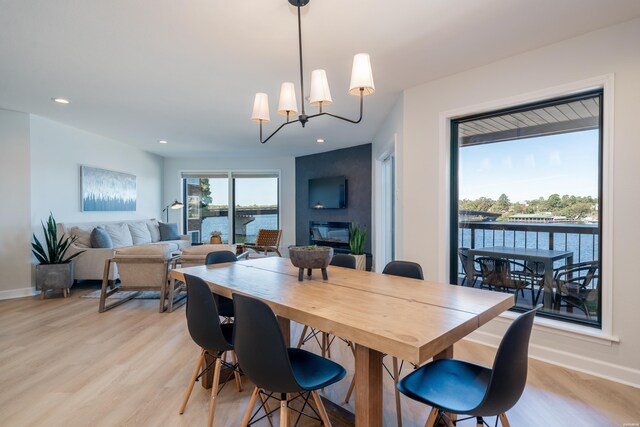 dining space featuring light wood-style floors, recessed lighting, a chandelier, and baseboards