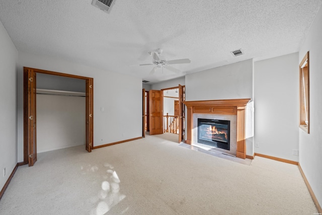 69 Resplandor Way, Hot Springs Village, AR 71909 - unfurnished living room with a fireplace, a textured ceiling, visible vents, and ceiling fan
