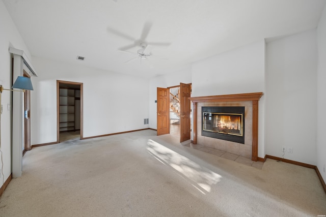 69 Resplandor Way, Hot Springs Village, AR 71909 - unfurnished living room with baseboards, visible vents, light colored carpet, a ceiling fan, and a fireplace