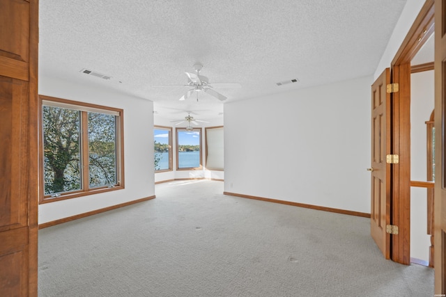 69 Resplandor Way, Hot Springs Village, AR 71909 - unfurnished room featuring light colored carpet, visible vents, and plenty of natural light