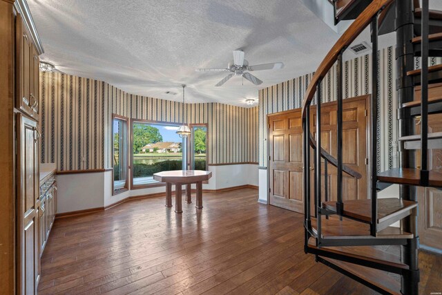 69 Resplandor Way, Hot Springs Village, AR 71909 - interior space featuring a ceiling fan, a textured ceiling, wallpapered walls, stairs, and baseboards