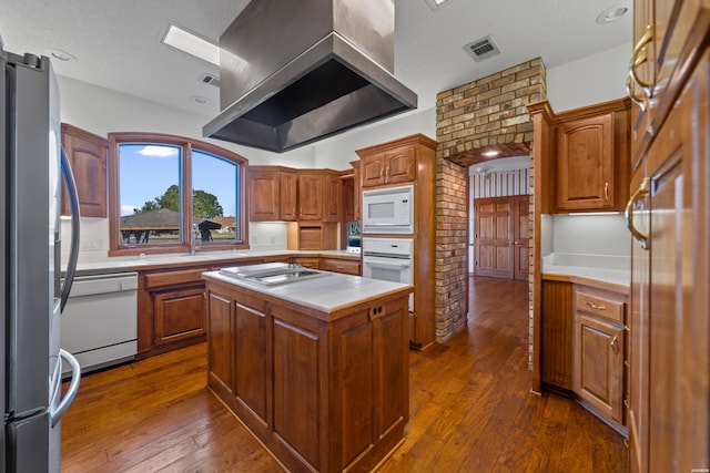 69 Resplandor Way, Hot Springs Village, AR 71909 - kitchen with tile counters, stainless steel appliances, visible vents, dark wood-type flooring, and wall chimney exhaust hood