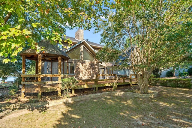 69 Resplandor Way, Hot Springs Village, AR 71909 - rear view of property featuring a chimney, a gazebo, a deck, and a yard