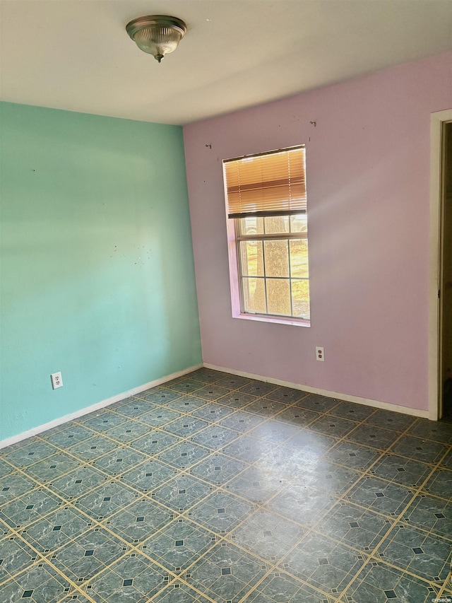 spare room featuring baseboards