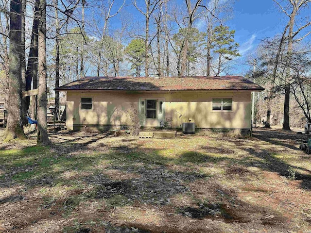 back of property featuring central AC