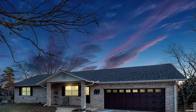 view of front facade with a garage, brick siding, driveway, and roof with shingles