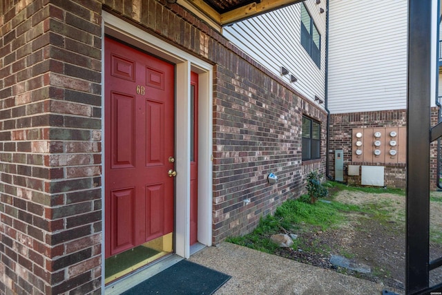 entrance to property with brick siding