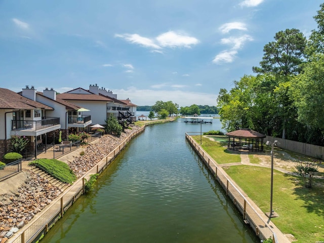 property view of water featuring fence and a gazebo