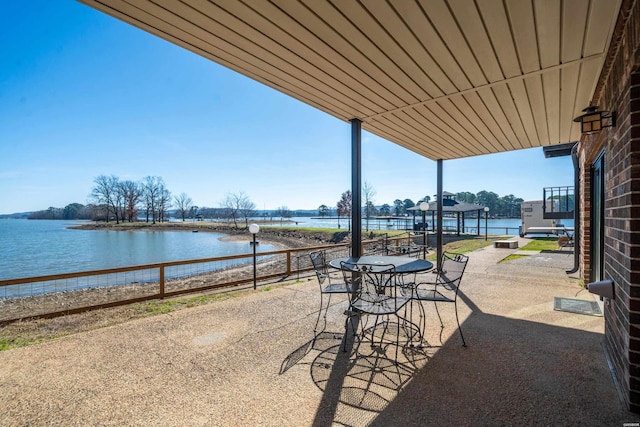 view of patio / terrace with a water view and outdoor dining area