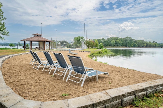 view of property's community with a water view and a gazebo