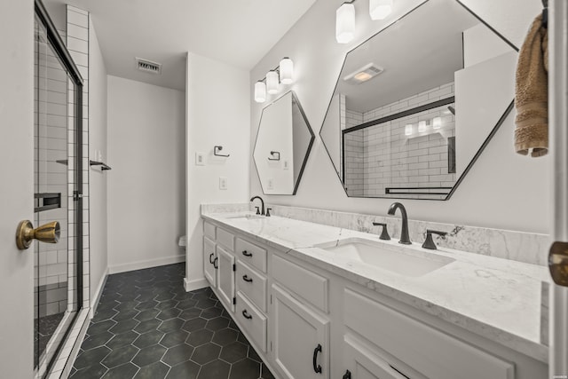 bathroom featuring visible vents, a sink, and tile patterned floors