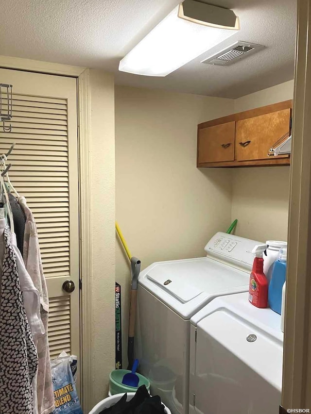 22 Huntleigh Dr, Hot Springs, AR 71901 - laundry area with washer and clothes dryer, cabinet space, and a textured ceiling