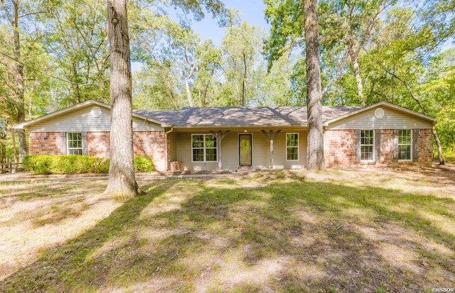 single story home with a front yard and brick siding