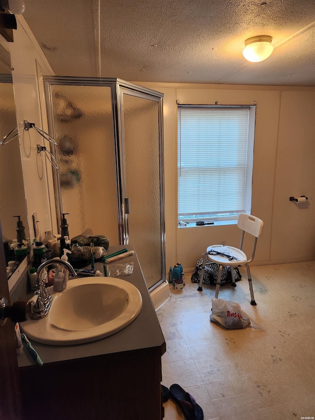 256 Shawnee Loop, Amity, AR 71921 - bathroom with vanity, a stall shower, and a textured ceiling