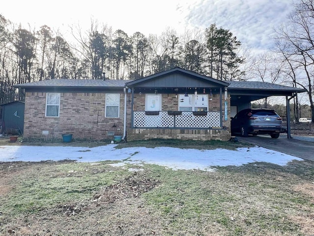 view of front of home with driveway, an attached carport, crawl space, and brick siding