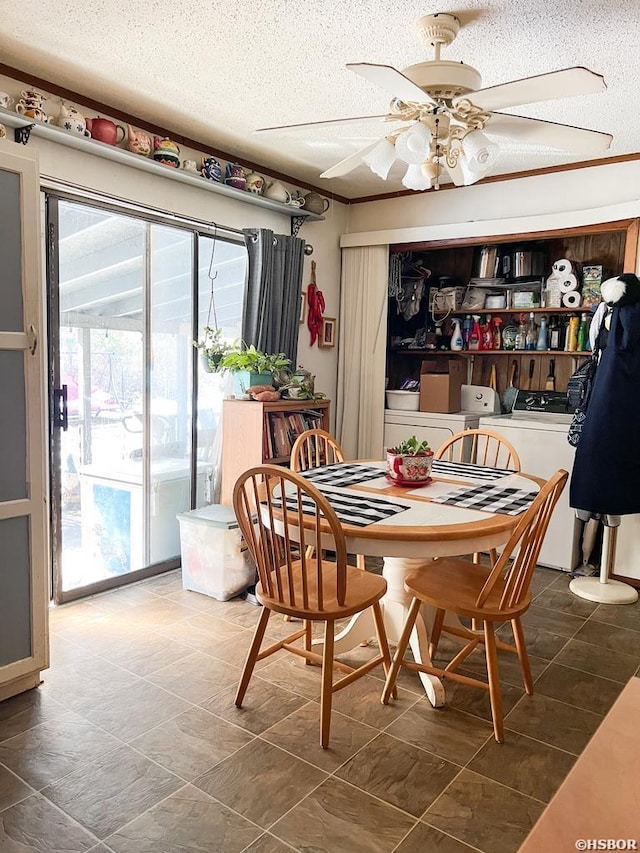 dining space featuring a ceiling fan, washing machine and dryer, and a textured ceiling