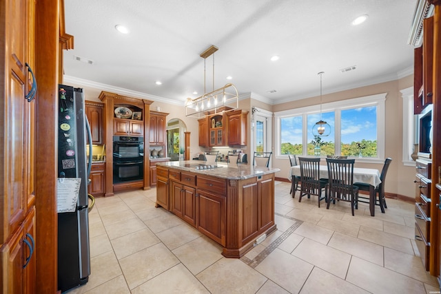 kitchen with arched walkways, pendant lighting, brown cabinetry, a kitchen island, and black appliances