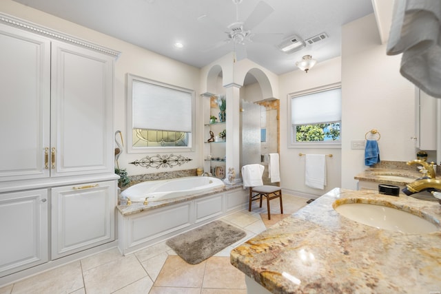 bathroom with ceiling fan, a garden tub, tile patterned flooring, vanity, and tiled shower