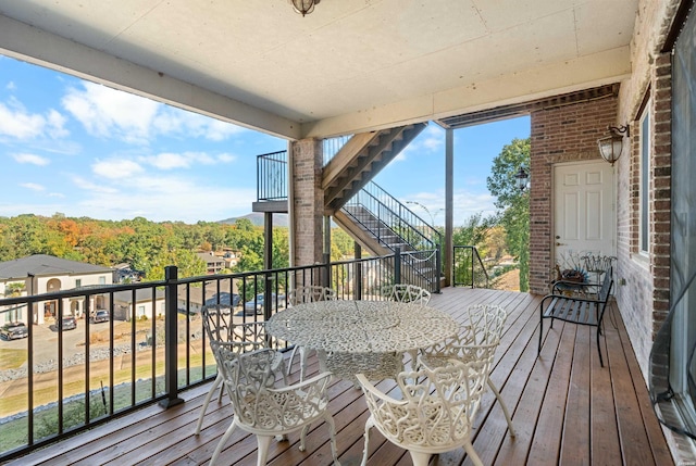 deck with stairs and outdoor dining space