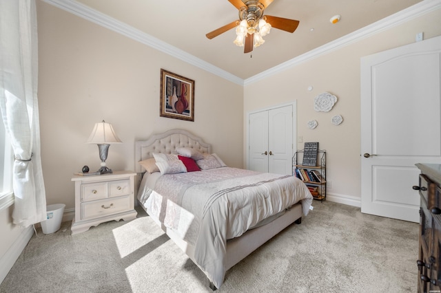 bedroom featuring light carpet, a closet, baseboards, and crown molding