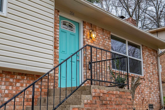 entrance to property with brick siding