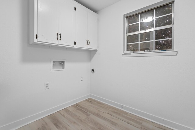 clothes washing area with hookup for a washing machine, hookup for an electric dryer, baseboards, cabinet space, and light wood finished floors