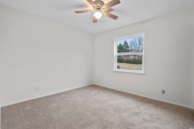 unfurnished room featuring carpet floors, a ceiling fan, and baseboards