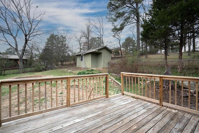 wooden deck with a fenced backyard and an outdoor structure