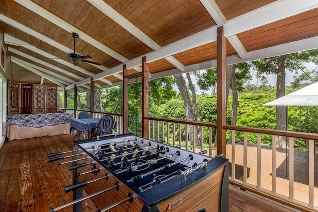 sunroom featuring plenty of natural light, vaulted ceiling with beams, ceiling fan, and wooden ceiling