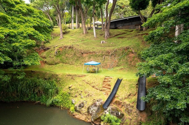 exterior space with a lawn and a water view