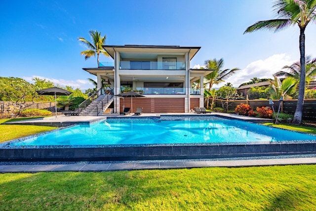 view of pool featuring a lawn