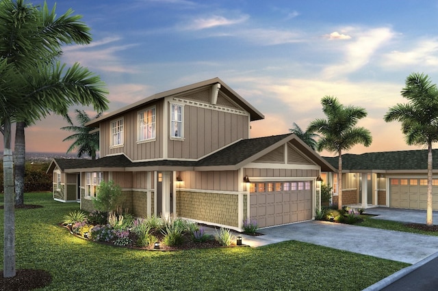 view of front of home with a yard and a garage