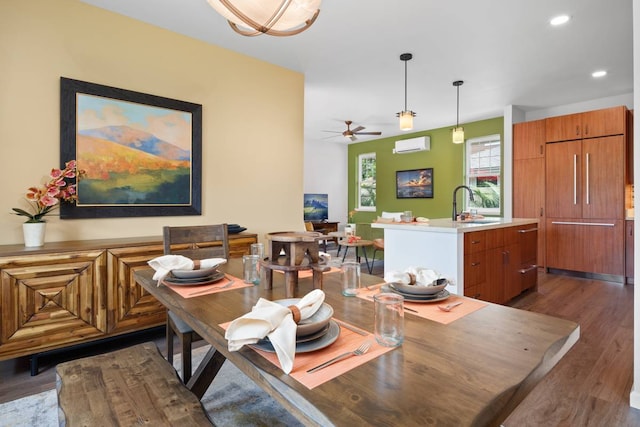 dining space with an AC wall unit, dark hardwood / wood-style floors, sink, and ceiling fan