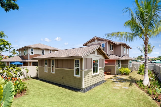 back of house with a lawn