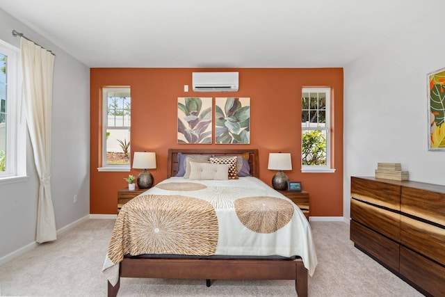 bedroom with a wall unit AC and light colored carpet