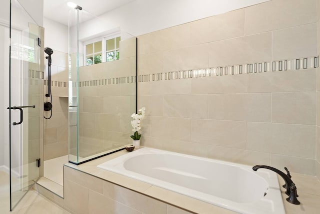 bathroom featuring tile patterned flooring and separate shower and tub