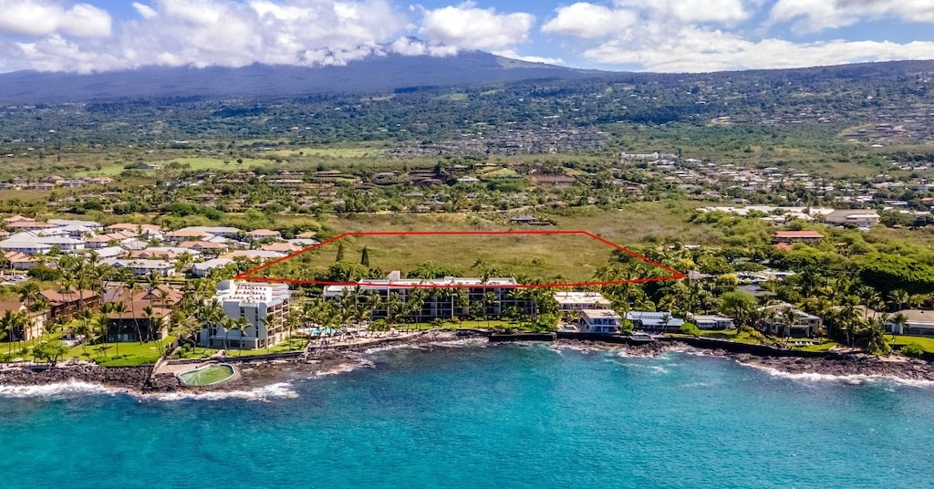 bird's eye view with a water and mountain view