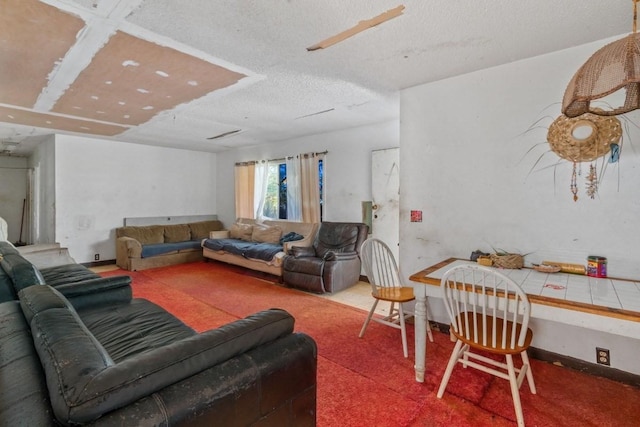 carpeted living room featuring a textured ceiling